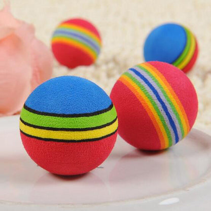 Rainbow Cat Ball Toys on a pale pinkbackground