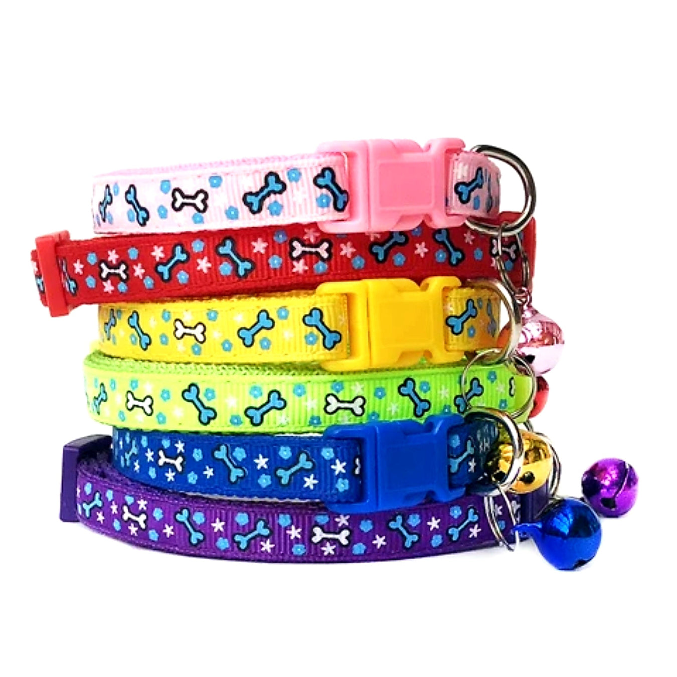A set of six colorful nylon puppy collars with bone patterns and side clips, in blue, red, yellow, green, purple, and pink, each adorned with a small bell.
