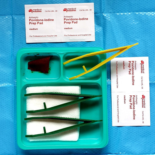 Sterile Dressing Kit with two iodine prep pads on a blue sterile sheet