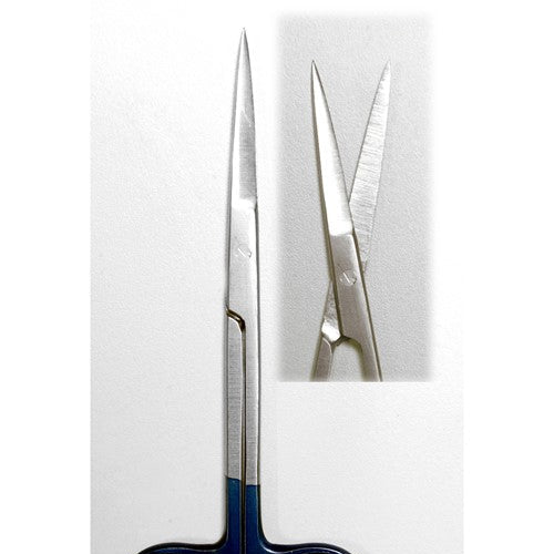 The tips of iris scissors on a white and grey background